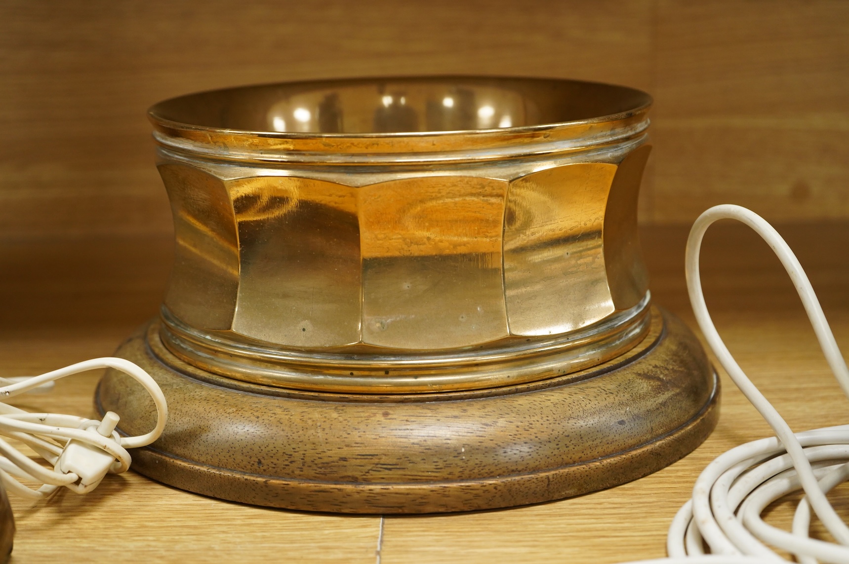 A bronze spitoon on plinth and a near pair of cartridge case table lamps, largest 46cm high